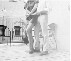 black and white photo of a man and a woman dancing intimately
