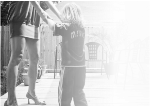 black and white photo of a mother and small child dancing